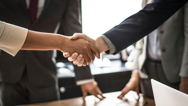 An image of a two people shaking hands that illustrates the comprehensive real estate title and closing services available at Boca Raton Real Estate Attorney,  ASR Law Firm.