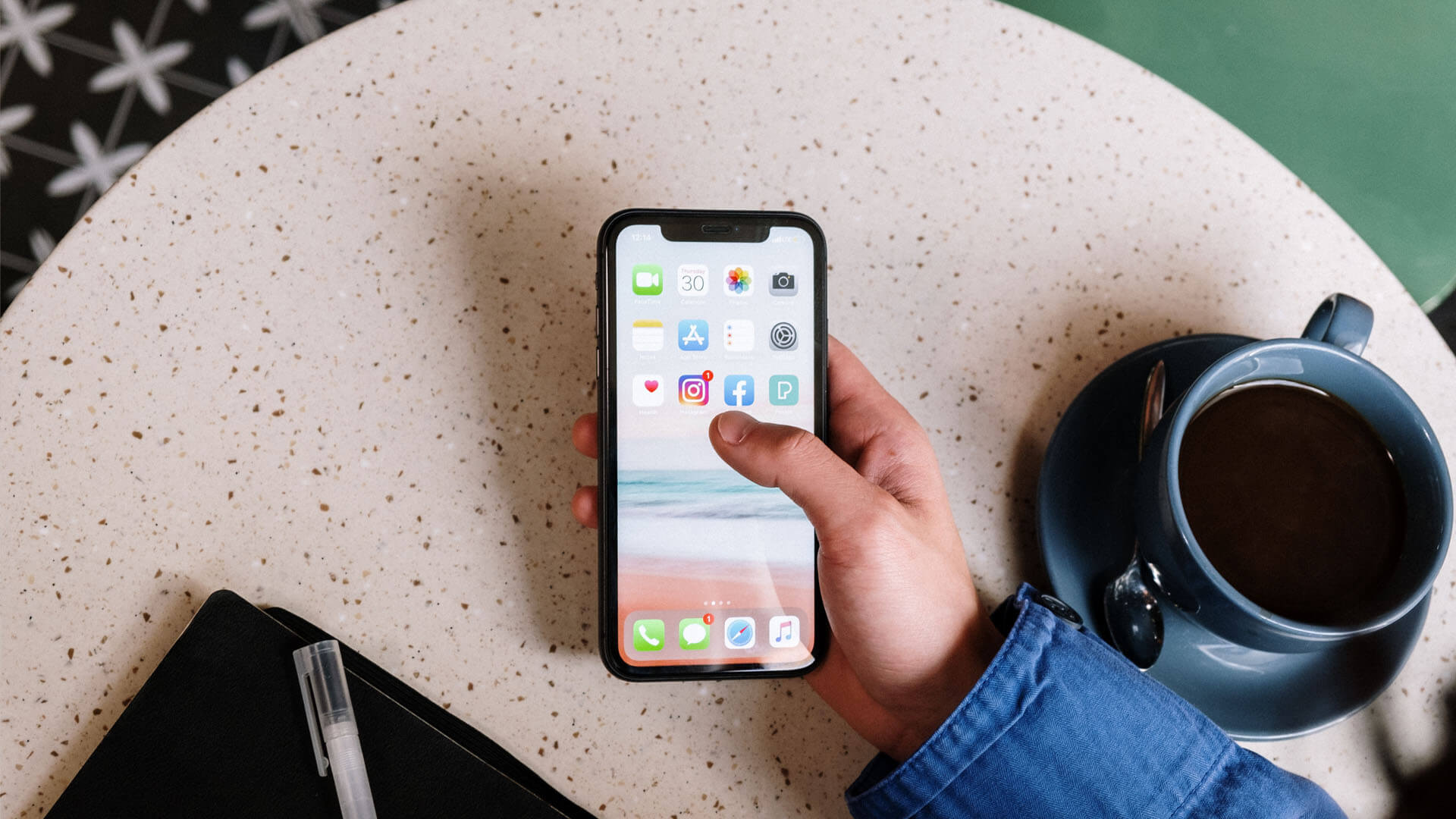 An image of a person on a smart phone going to social media that is the primary featured photo for the article Trademark Protection & Social Media: 3 Important Considerations for business owners.