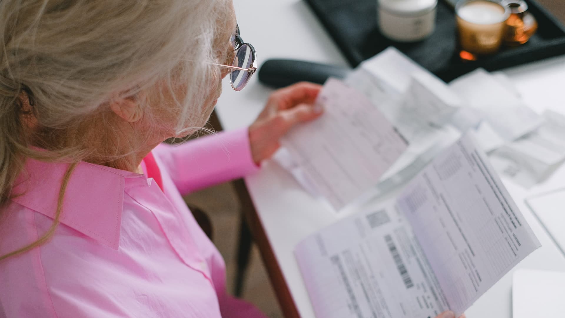 An image of a woman reviewing her estate planning documents as part of a yearly estate planning audit. 