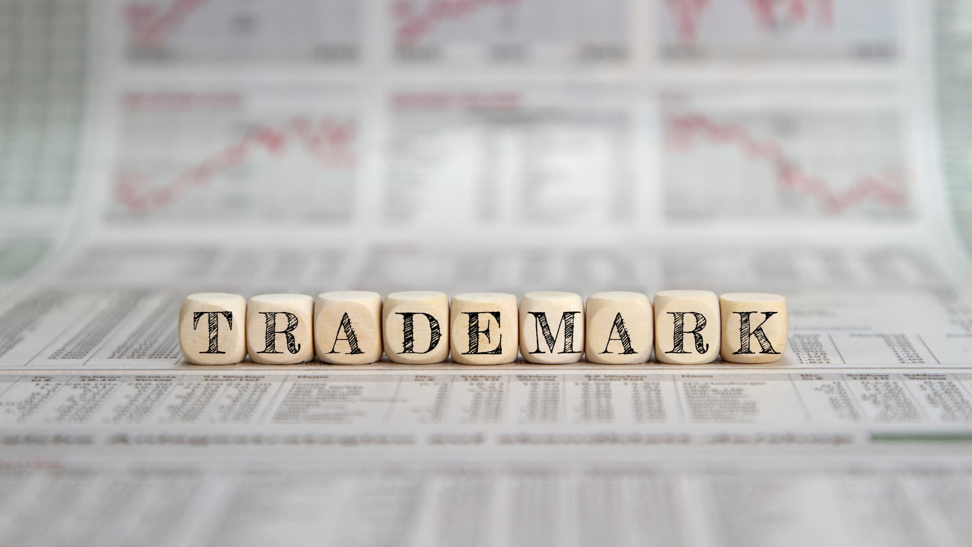 An image of letter blocks spelling out trademark on newspaper!