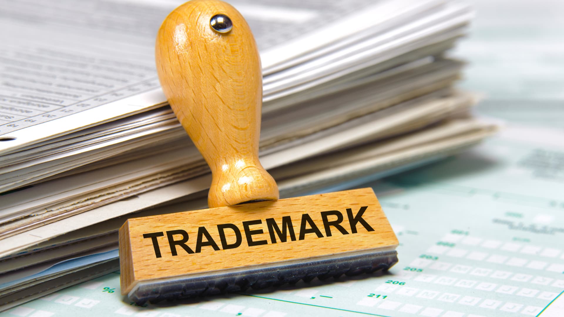 An image of a trademark stamp on top of a pile of documents.
