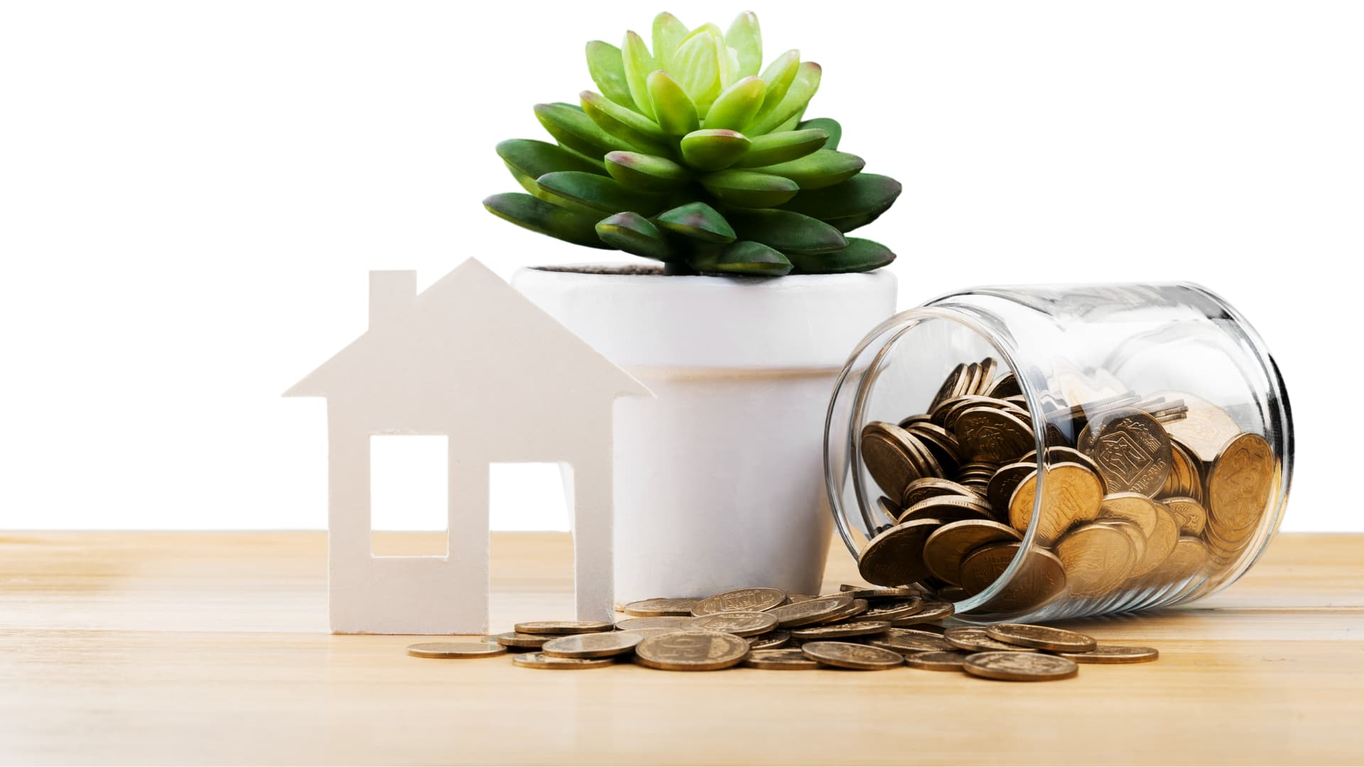 An image of a staged house with a money jar next to it. 