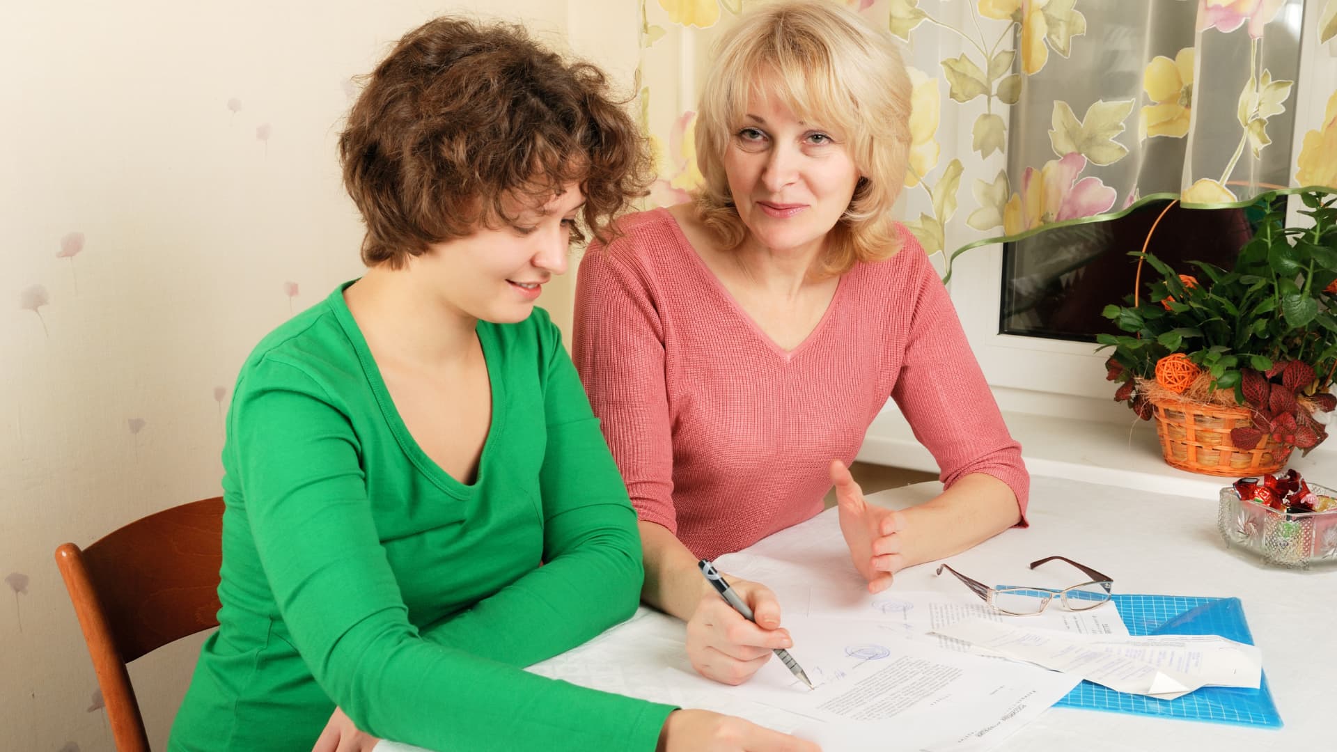 An image of a mother and daughter going over the daughter's estate planning documentation. 