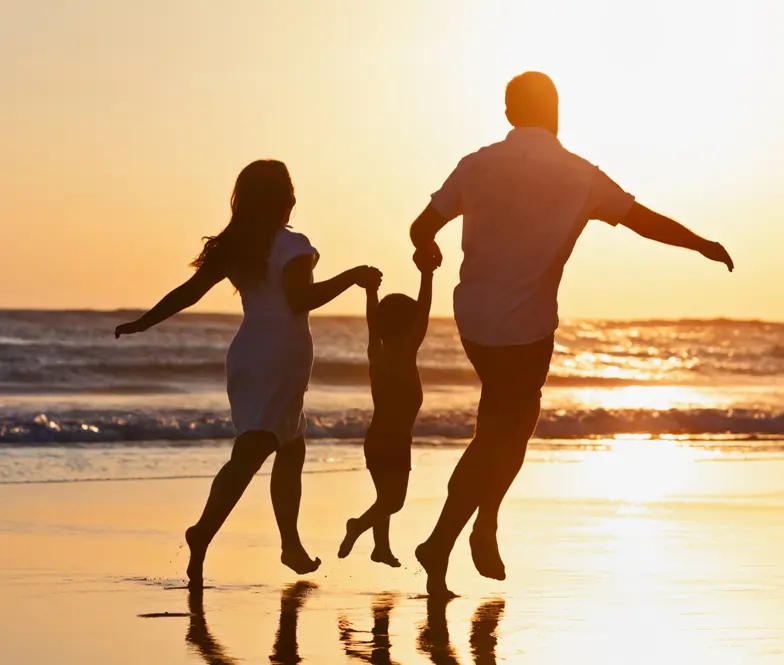 An image of a family holding hands on a beach showing illustrating the comprehensive estate planning services provided at ASR Law Firm of Boca Raton.