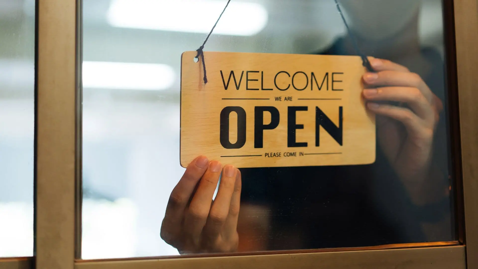 An image of an open sign on a business storefront showing the business law solutions from asr law firm.