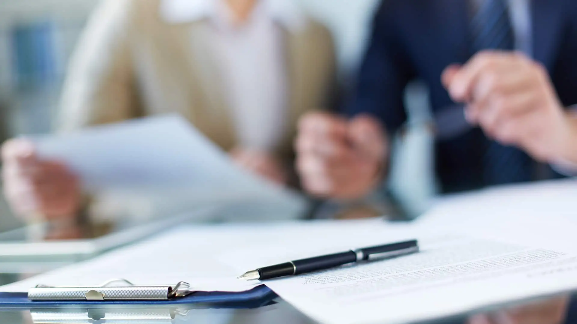 An image of an older couple discussing property transfers.