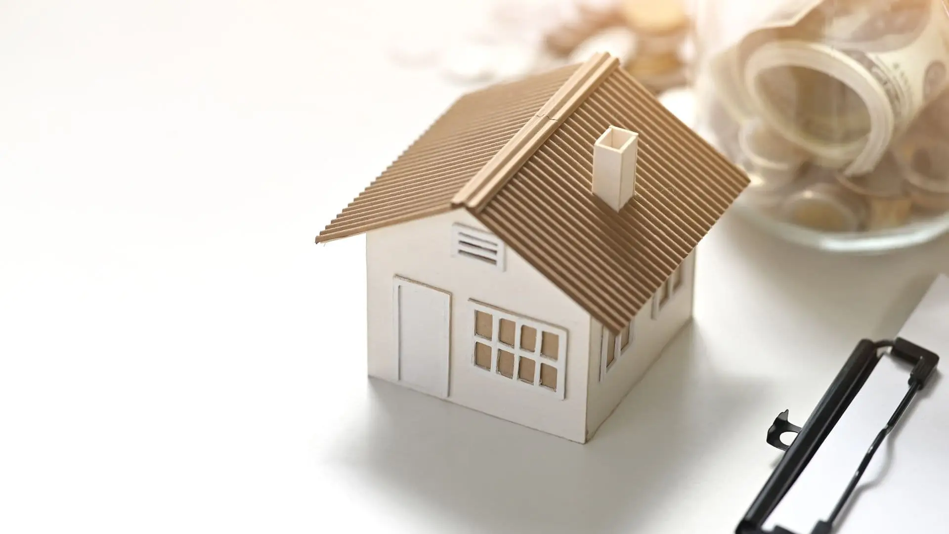 An image of a home model and money that represents how to avoid probate in florida.