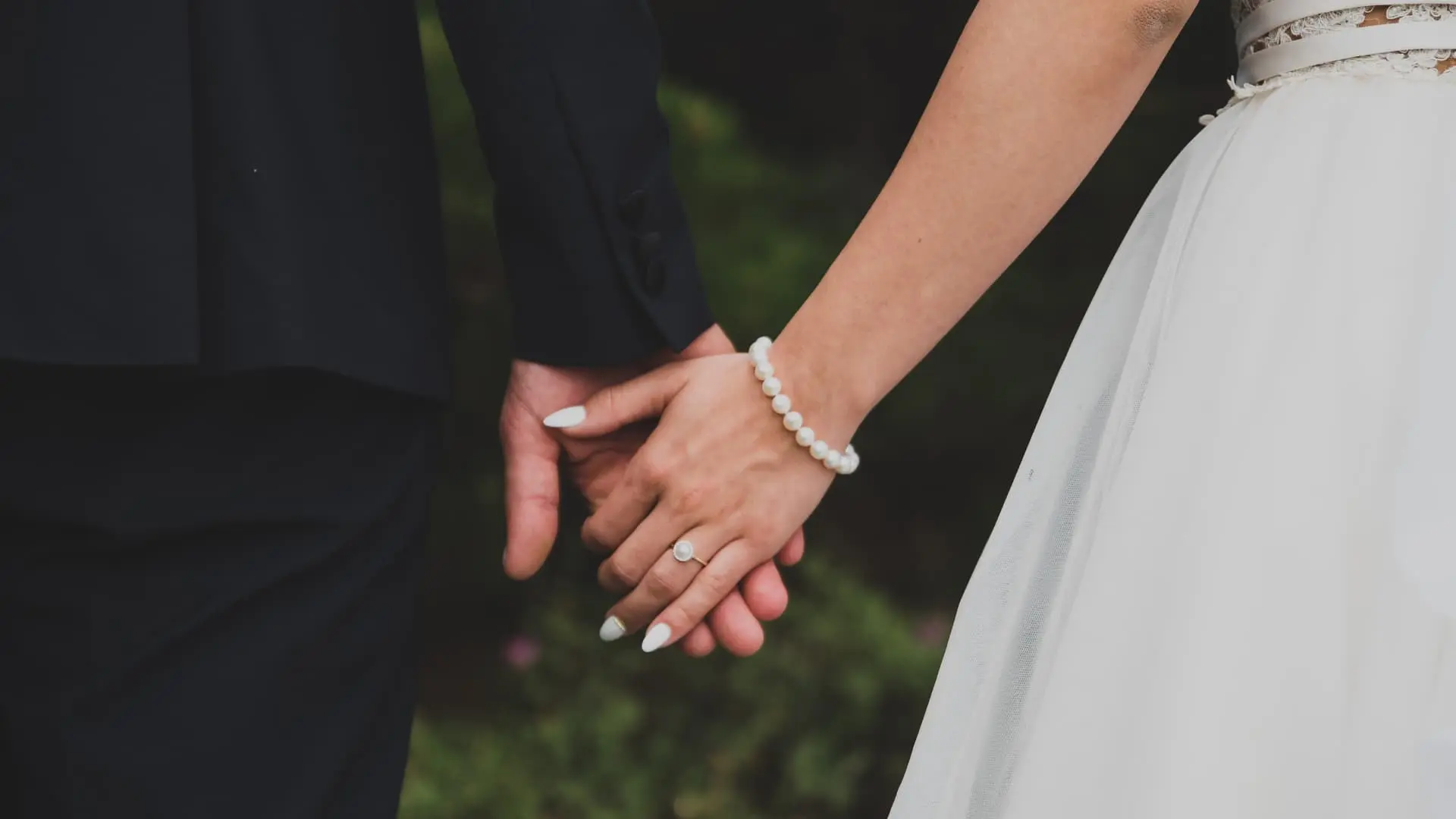 An image of a bride and groom holding hands showing joint revocable trusts for married couples in florida.