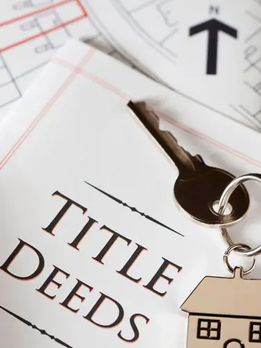 An image of a Florida Title Deed with a house key on it showing Florida Deed Transfers