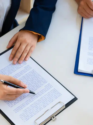 An image of a client and lawyer going over a power of attorney. 