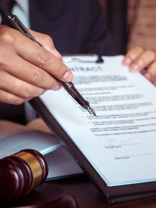 An image of an attorney pointing to a power of attorney with a pen. 