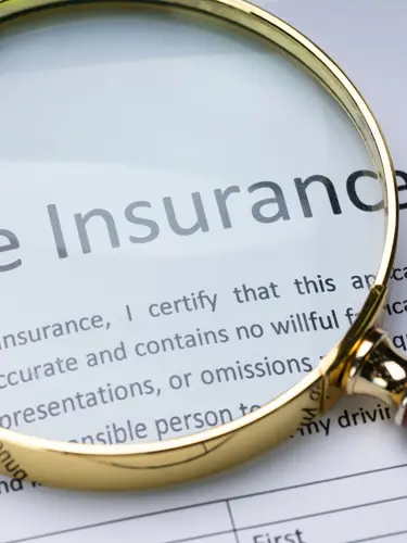 An image of title insurance under a close-up of a magnifying glass. 