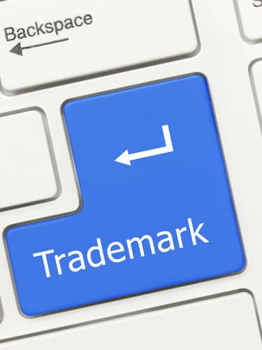 An image of a computer keyboard key with the words "Trademark" written on it showing the trademark services provided at asr law firm of boca raton florida. 
