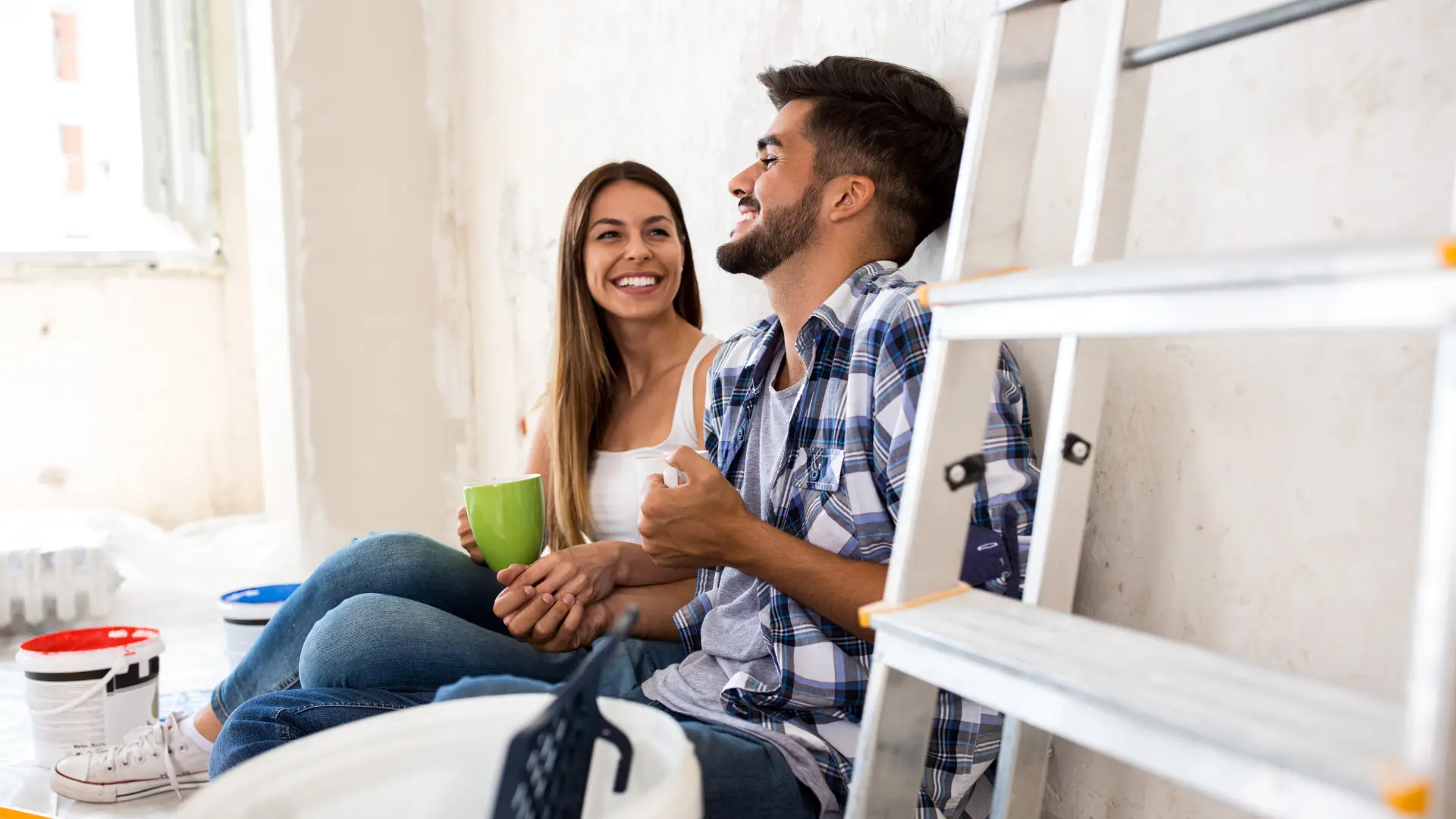 An image of a young couple that has just bought a home showing how ASR Law Firm helps young homebuyers. 