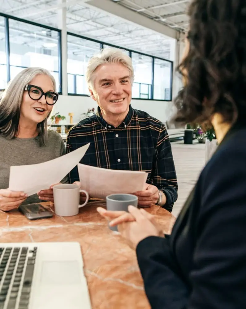 An image of a couple sitting with an estate planning attorney to discuss Probate Avoidance. 