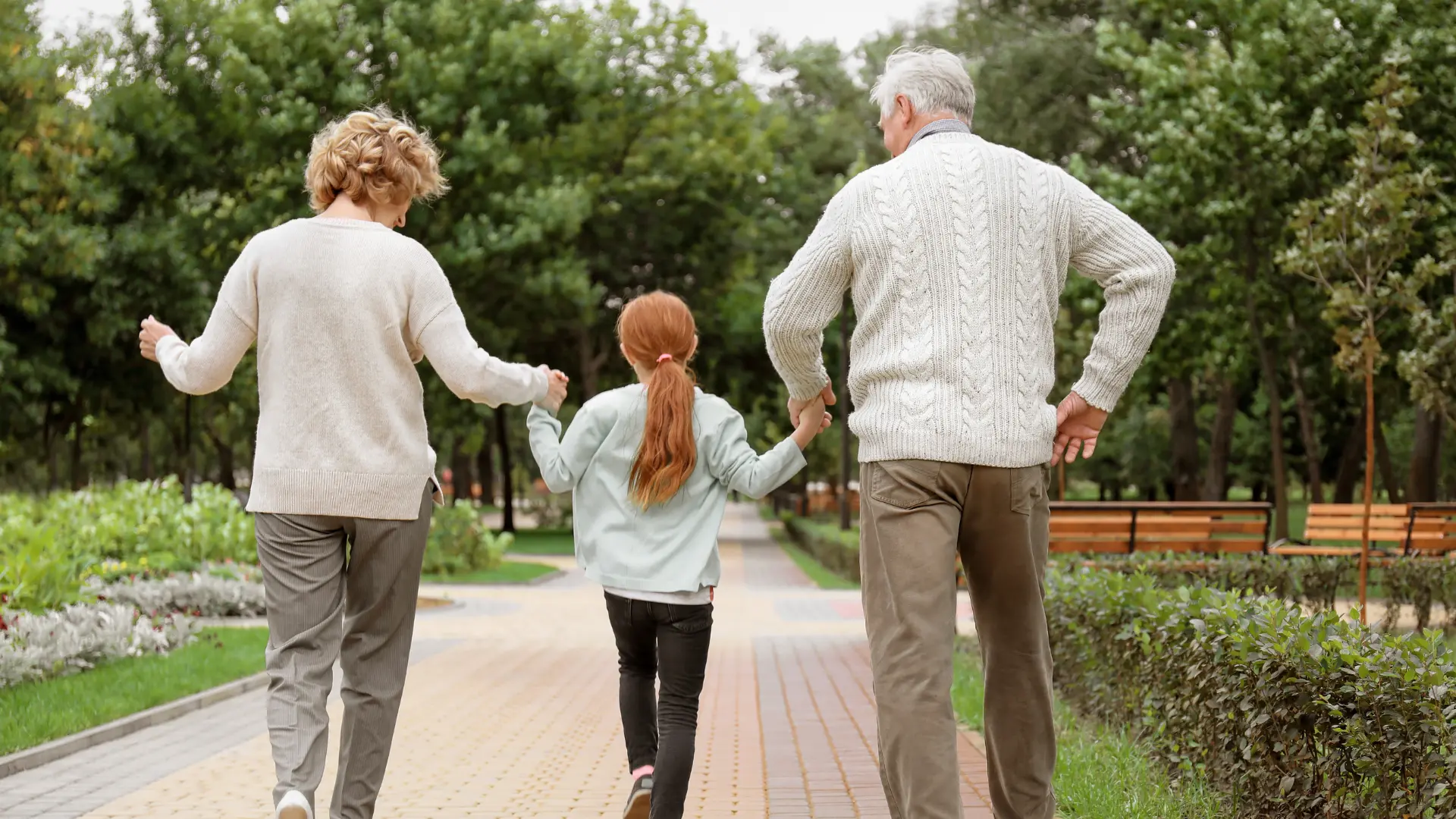 An image of grandparents taking a child for a walk showing how to choose the right guardian for children in florida. 