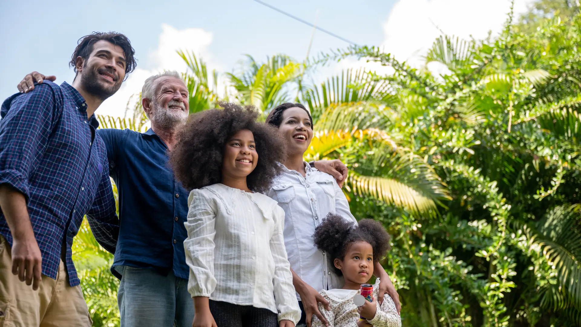 Multigenerational Florida family smiling together outdoors representing the importance of estate planning to protect family assets
