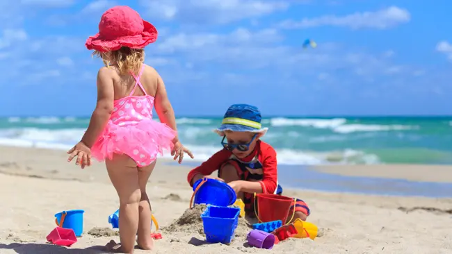 Young family with children enjoying Florida beach after relocating to Boca Raton Palm Beach County